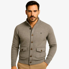 Modelo masculino usando cardigan caqui de botão com bolsos frontais, estilo social casual, calça chino bege. Ideal para outono/inverno